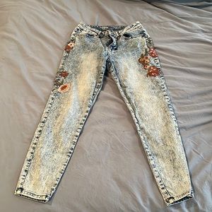 Distressed blue jeans with floral print